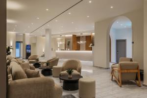 a lobby with a waiting room with chairs and tables at Diana Palace Hotel Zakynthos in Argassi