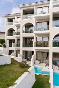 an exterior view of a building with a swimming pool at Diana Palace Hotel Zakynthos in Argassi