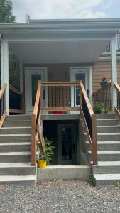 a house with a staircase leading to the front door at Appartement tout inclus - Longs séjours in Mirabel