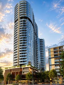 a tall glass building with a sky at Rise to the top! in Melbourne