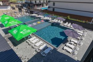 an overhead view of a pool with chairs and umbrellas at Fenix in Solotvyno