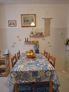 a dining room table with a blue and white table cloth at Angolo Azzurro in Asciano Pisano +24 photos