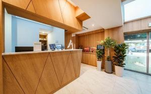 an office with a reception counter and potted plants at Hotel Seven Step in Incheon