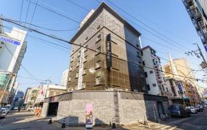 a tall building on a city street with at Hotel Seven Step in Incheon
