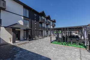 a courtyard of a building with chairs and a pavilion at Fenix in Solotvyno