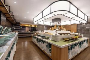 a buffet line in a restaurant with dishes at Atour Hotel Shuangyong Ave in Yan'an