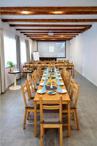 a conference room with a large wooden table and chairs at Penzion Hněvotín 88 in Hněvotín