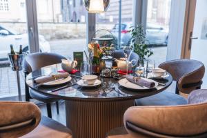 a table in a room with chairs and a table with food at Hotel zum Kaiserdom in Speyer