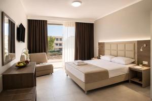 a hotel room with a bed and a window at Perla Halkidiki in Kallithea Halkidikis +23 photos