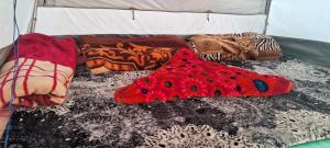 a group of pillows on a bed in a tent at Gurez valley camping site in Gurais