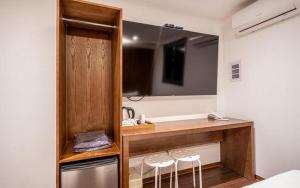 a room with a counter with two stools and a mirror at Hotel Seven Step in Incheon +32 photos