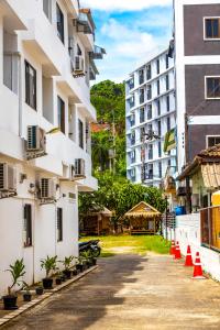 a street in a city with buildings and orange cones at Patong Canal Villa 208 in Patong Beach