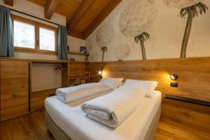 a bedroom with two beds with white pillows at Maison Luboz - Courmayeur in Courmayeur