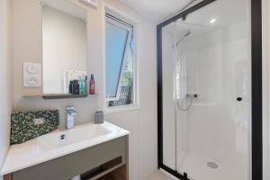 a bathroom with a sink and a shower at Mobilehome Evasion 55 in Saint-Gervais +13 photos