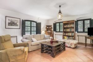 a living room with a couch and a coffee table at Cortijo Cantarranas - Tarifa in Tarifa