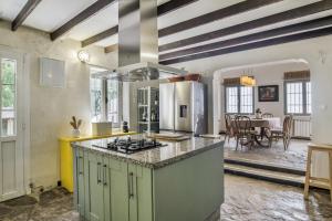 a large kitchen with a stove top oven at Cortijo Cantarranas - Tarifa in Tarifa