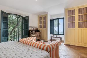 a bedroom with a bed and a balcony at Cortijo Cantarranas - Tarifa in Tarifa +33 photos