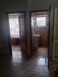 a bathroom with a sink and a window and a door at Ośmiorniczka Skorzęcin in Skorzęcin +13 photos