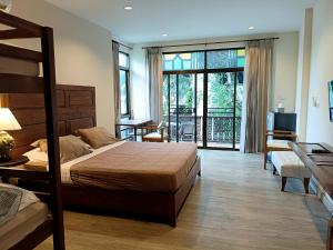 a bedroom with a bed and a living room at Mountain View GuesthouseChiangmai in Chiang Mai