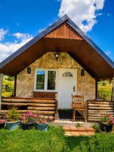 a small stone house with a white door at Konak in Podgorica