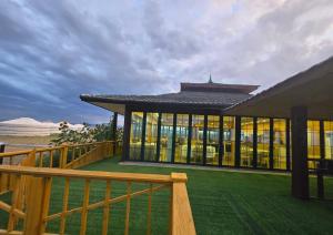 a large building with windows and a wooden fence at Gobi Sun Lodge in Hushuu Hural