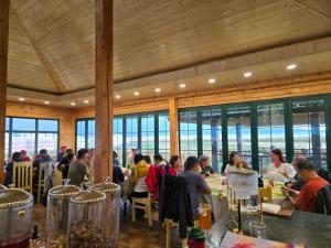 a group of people sitting at tables in a restaurant at Gobi Sun Lodge in Hushuu Hural
