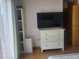 a dresser with a flat screen tv on top of it at Bellavista in Piedralaves