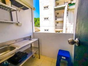 a kitchen with a view of a building at Patong Canal Villa 208 in Patong Beach