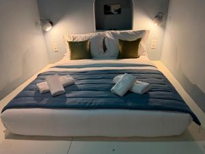 a large bed with two pillows on top of it at Dimael Mansion in Fira +63 photos