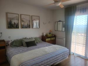 a bedroom with a large bed and a window at Bellavista in Piedralaves +23 photos