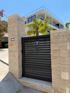 a black garage door with the number in front of a house at Villa Richard in Sutomore