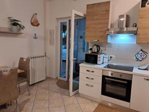 a kitchen with a sink and a microwave at Dorea in Jagodje +15 photos