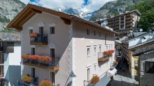 a group of buildings with flower boxes on their balconies at Maison Luboz - Courmayeur in Courmayeur