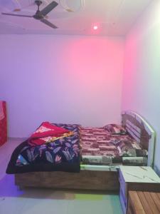 a bedroom with a bed and a pink wall at Cosy Paradise in Ādbadri