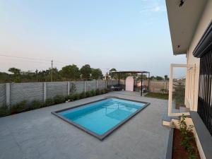 a swimming pool in the backyard of a house at Sunset Villa in Mysore