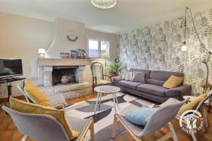 a living room with a couch and a fireplace at Ar gwelva in Cléguérec