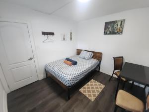 a small bedroom with a bed and a table at Affordable Quiet Private Room - 10-min Walk to Subway in Toronto