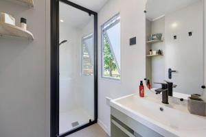a white bathroom with a sink and a shower at Mobilehome Vallon 57 in Saint-Gervais +17 photos