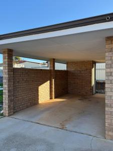 an empty garage with a brick wall at Corner unit in Geraldton in Geraldton