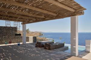 a patio with a view of the ocean at AOTO Villas in Kithnos