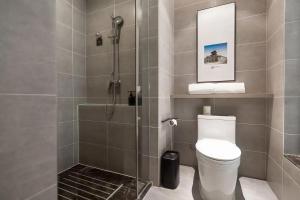 a bathroom with a shower with a toilet and a sink at Atour Hotel Shuangyong Ave in Yan'an