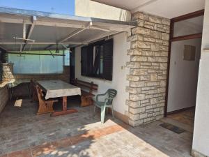 a patio with a ping pong table and a stone wall at Norma 2 in Novigrad Istria