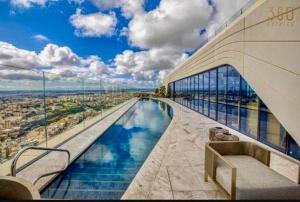 a view of a building with a swimming pool at Sky Apartment , 22th Floor Mercury Tower in St. Julianʼs