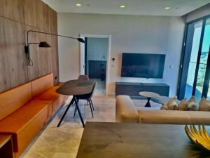 a living room with a couch and a table at Sky Apartment , 22th Floor Mercury Tower in St. Julianʼs