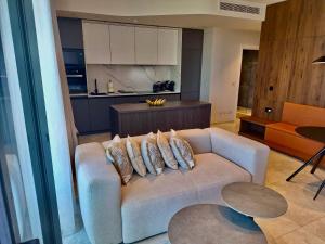 a living room with a couch and a kitchen at Sky Apartment , 22th Floor Mercury Tower in St. Julianʼs