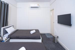 a bedroom with a bed and a flat screen tv at Loop by Zolo HSR Layout, Bangalore in Bangalore