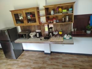 a kitchen with a counter top with a refrigerator and a counter top at Ninas Beach Resort in Habaraduwa Central +10 photos