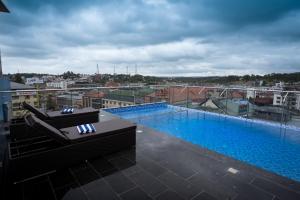 a large swimming pool on top of a building at Luxo Wayanad in Sultan Bathery