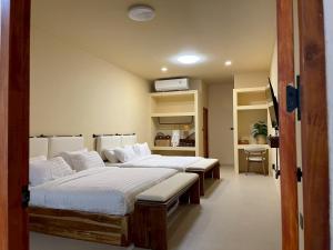 a room with two beds in a room at Pani house in Ko Samed
