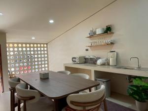 a kitchen with a table and chairs and a sink at Pani house in Ko Samed